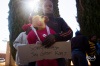A supporter for the accused with a toy bear wearing a AWB T-Shirt and his sentiment.