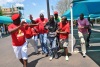 The man is escorted out of the Cosatu rally...