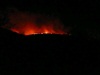 The glow of the fire on the mountain tops.
