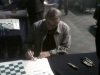Garry Kasparov signs all the boards used for the chess exhibition