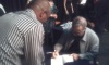 A grateful fan gets his copy of Fighting Chess (book on Garry Kasparov's career) signed by the man himself.