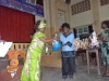 The deputy governor Hansel Katana offers an award to best runners in a choral verse (Rodgers Buluma, News24 user)