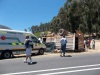 It appears the paramedic is standing around and someone is taking pictures of the scene /paramedic