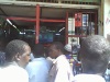 Kenyans cluster in the door way of an electronic shop to follow the election results on a television.