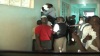 Students from Kenyatta university crowding on the door harboring the alleged IEBC officers