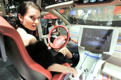 A hostess sits in the futuristic cockpit of the new Cadillac Villa concept car designed by Bertone during the press day at Geneva International Motor Show in Geneva, Switzerland(AP Photo/Keystone, Martial Trezzini)