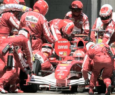Mechanics work on Michael Schumacher's car at the Spanish GP. (Bernat Armangue, AP) 