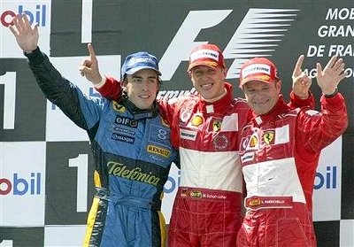 Michael Schumacher, centre, with his Ferrari teammate Rubens Barrichello and Renault driver Fernando Alonso, left, pose on the podium after the French Formula One Grand Prix. (Michel Euler, AP)
