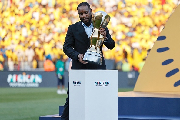 Former Nigeria national team star Jay-Jay Okocha holding the African Football League trophy.