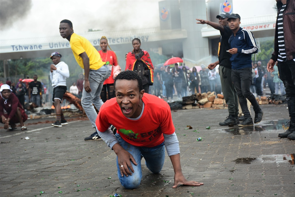 Protesting students use burning tyres and bricks to block the entrance gate of Tshwane University of Technology Pretoria Campus, during a previous protest.