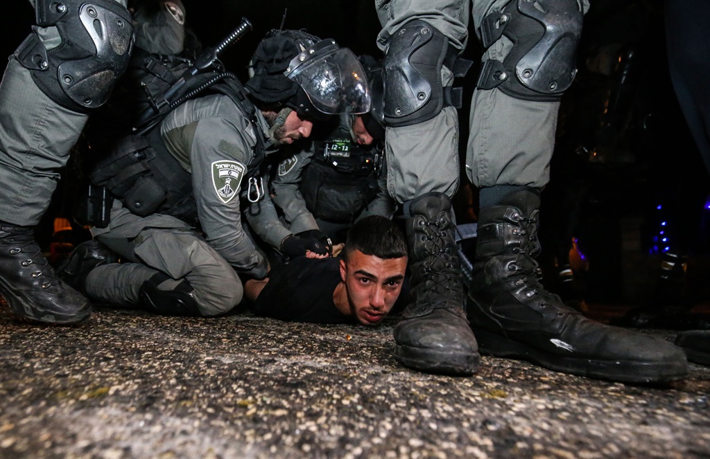  Israeli forces take a Palestinian into custody du