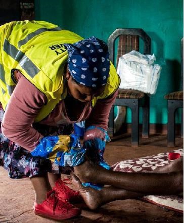 A community health care worker cleans an elderly woman during her visits around the community of Sweet Waters in KwaZulu-Natal.
