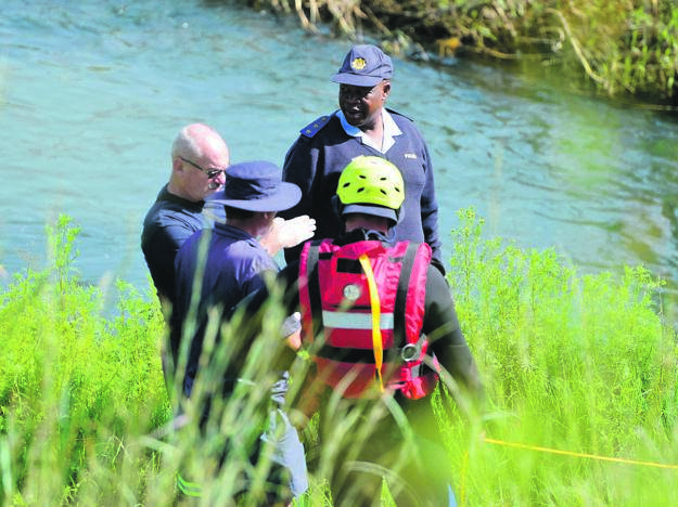 Captain Kay Makhubele (back) with the search and rescue team at the river near Fun Valley yesterday.              Photo by Trevor Kunene