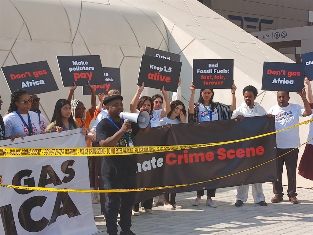 A small crowd of climate change protestors at COP28 in Dubai