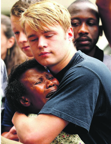 People comfort one another outside former president Nelson Mandela’s house in Johannesburg on December 6 2013, the day after the icon died                                                   Picture: Siphiwe Sibeko