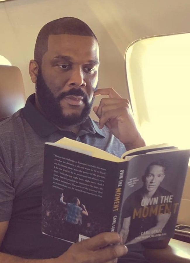 Tyler Perry is a long time friend of Carl Lentz, and posted a picture of himself reading Carl's 2017 memoir, Own the Moment, to Instagram. (CREDIT: Instagram / @tylerperry)