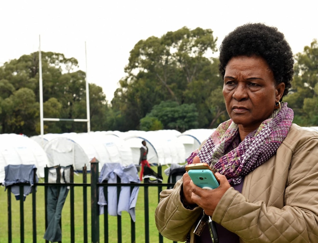 Francinah Matlala stands inside the Trans Oranje rugby field in Pretoria West, which is housing homeless people for the duration of the lockdown.  Matlala is hoping to come across her nephew Tebogo Joseph Sadick. Picture: Tebogo Letsie/City Press