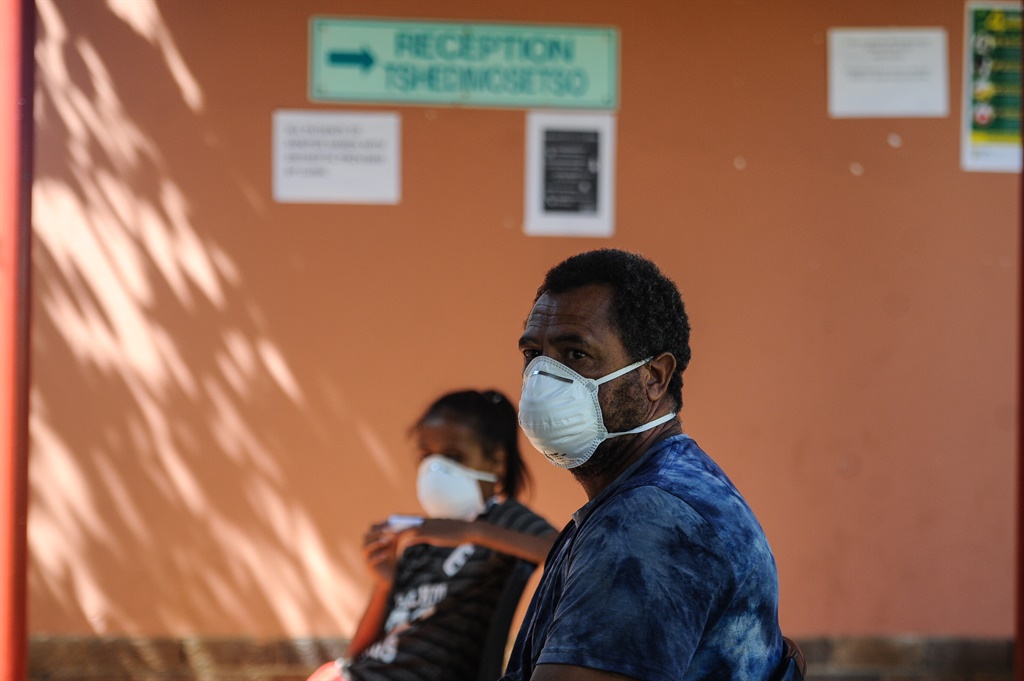 Leo Donald and his daughter wait to get tested for Covid-19 at the Rex Clinic in Rooderpoort. Picture: Rosetta Msimango/City Press