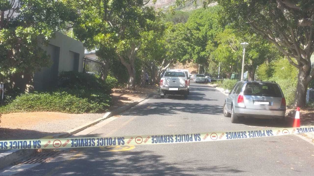 Police at the scene of the home of top criminal attorney William Booth in Cape Town after he survived an attempted hit while in his garage. (Murray Williams, News24)
