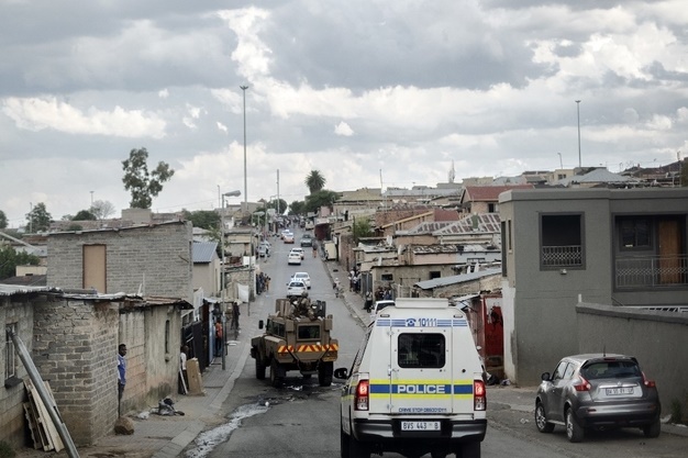 Vehicles of the South African National Defence Force (SANDF) and the South Africa Police Service (SAPS) patrol the streets of Alexandra, Johannesburg. (Luca Sola/AFP)