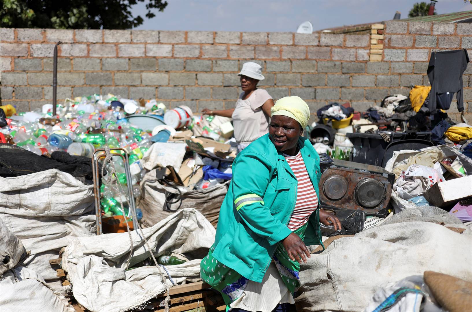 Waste pickers Abigail Kubheka and Adelina Nkopane sort out recyclable material amid the spread of the coronavirus disease in Soweto. Picture: Siphiwe Sibeko/Reuters