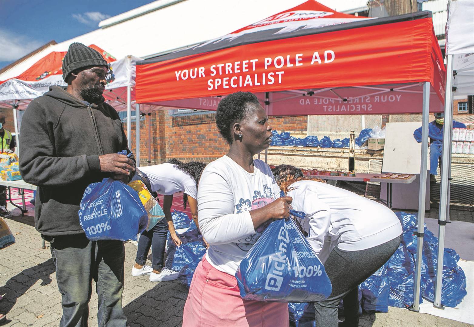 Orlando waste pickers receive food parcels at the community hall in Soweto. The City of Johannesburg has taken on the responsibility of ensuring that waste pickers have food PHOTO: sharon seretlo / Gallo images