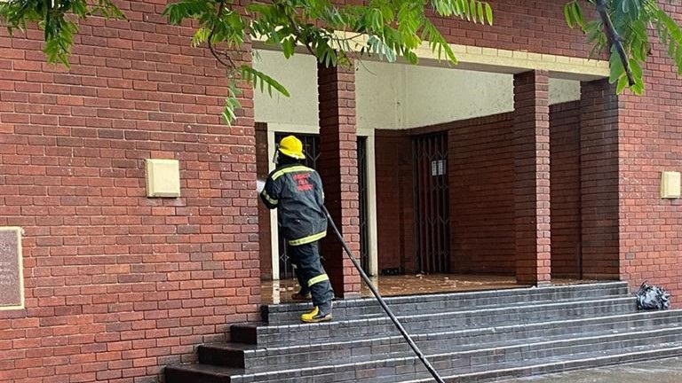 Firefighter cleans kak outside the town hall.