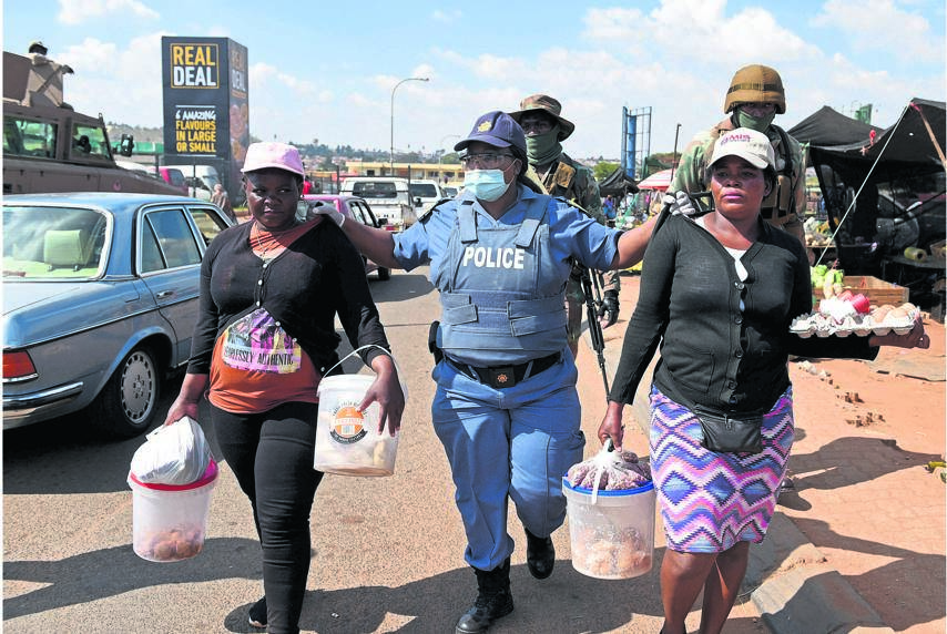 During lockdown enforcement in Soweto on Thursday, two woman are arrested for selling cake and snacks on the side of the road without a permit. Adherence to the lockdown restrictions is vital to lower transmissions and make the lifting of the lockdown easier. Picture: Tebogo Letsie