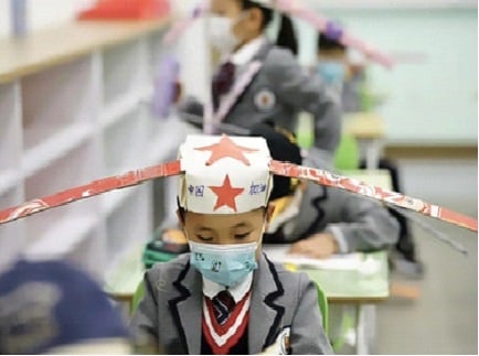adorable children each wearing a surgical mask as 
