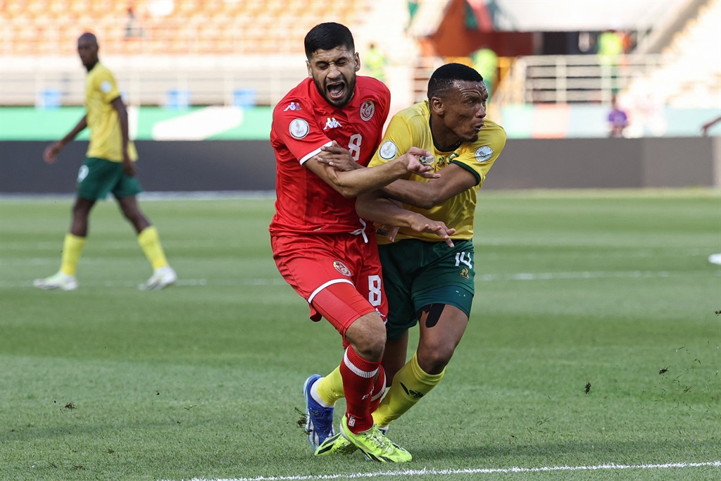 Tunisia's midfielder #8 Hamza Rafia fights for the ball with South Africa's defender #14 Mothobi Mvala during the Africa Cup of Nations (CAN) 2024 group E football match between South Africa and Tunisia at the Amadou Gon Coulibaly Stadium in Korhogo on 24 January 2024. 