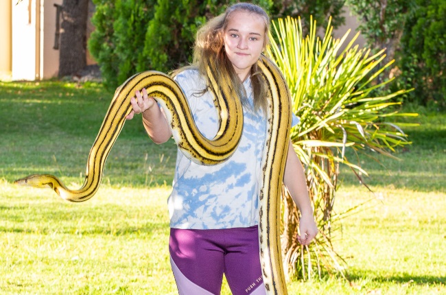 Christon Kriel (16) with her  2,8-m python, Daddy. (PHOTO: Onkgopose Koloti)