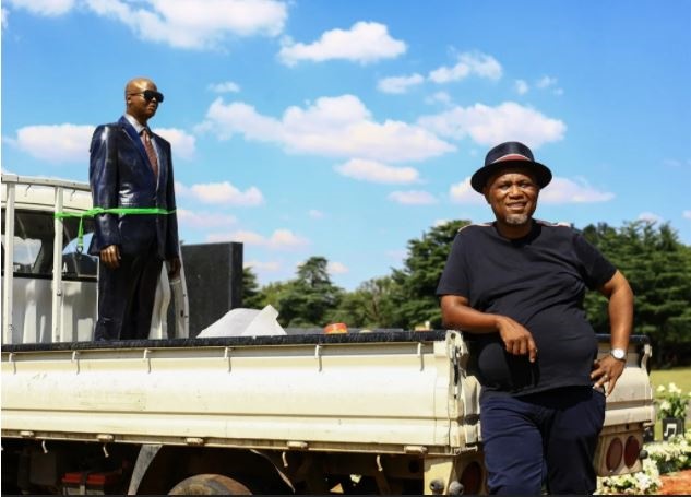 Artist and businessman Lebohang Khitsane is seen next to a truck transporting the statue of the late musician Robbie Malinga . (Photo by Gallo Images / Sunday Times / Veli Nhlapo)