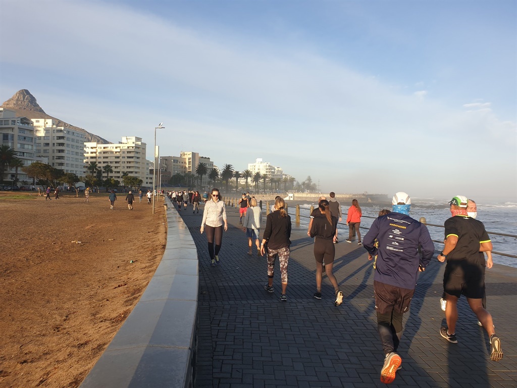 Joggers and walkers on the Sea Point promenade on Friday morning for the first day of level 4 lockdown. (Paul Herman/News24)