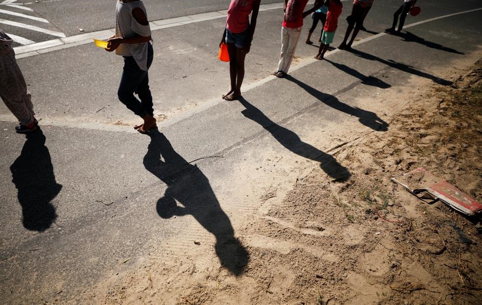 Children queue for food at a school feeding scheme during a nationwide lockdown aimed at limiting the spread of the Covid-19 in Blue Downs township near Cape Town. Picture: Mike Hutchings/Reuters