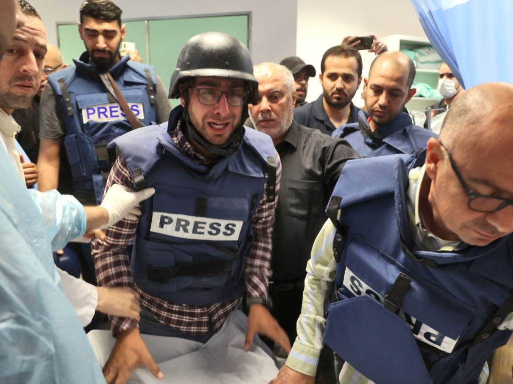Journalists escort the body of veteran Al Jazeera 