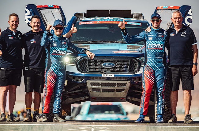 Gareth Woolridge and Boyd Dreyer with members of the Ford M-Sport team at the 2024 Dakar Rally.