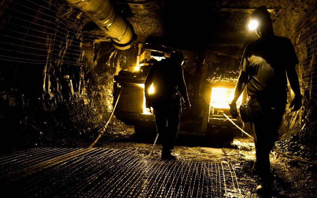 Two workers in an underground mine.  
