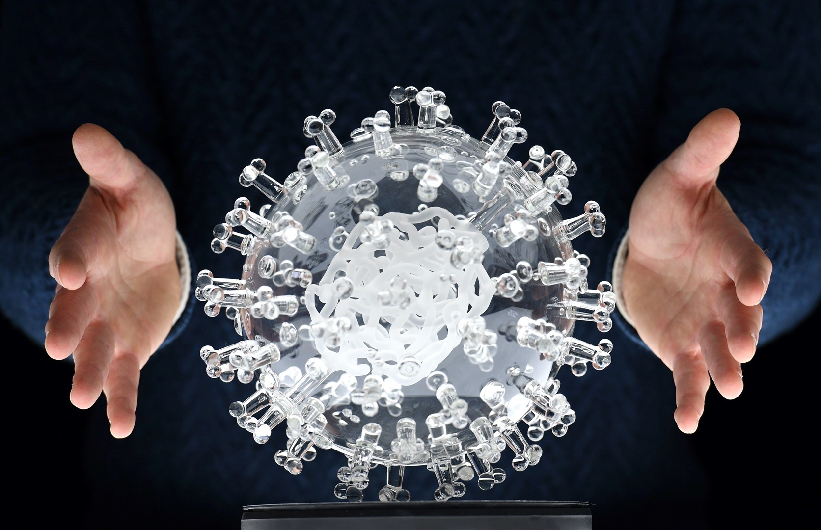 A glass model of the novel coronavirus, which causes the disease Covid-19, by the artist Luke Jerram in the UK on 18 March. The model is about 1 million times as large as the actual virus.