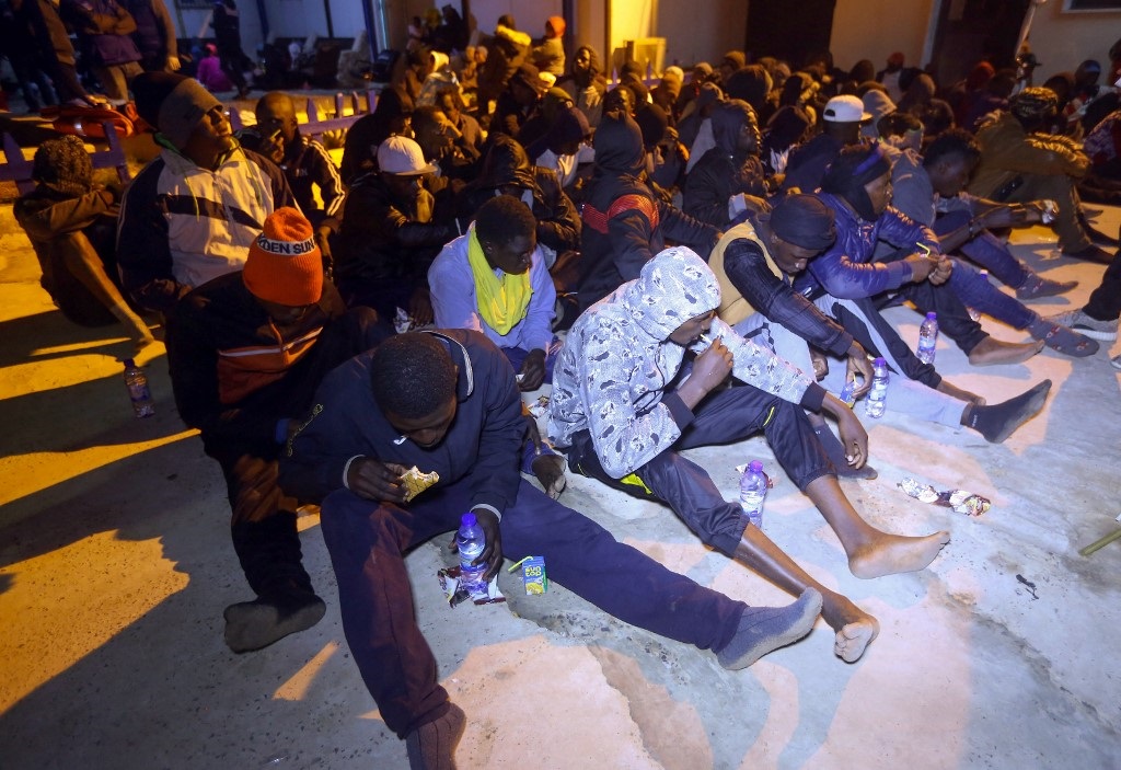 Migrants sait on the floor at a detention centre in Libya's Tajoura, in the eastern suburbs of the capital Tripoli.