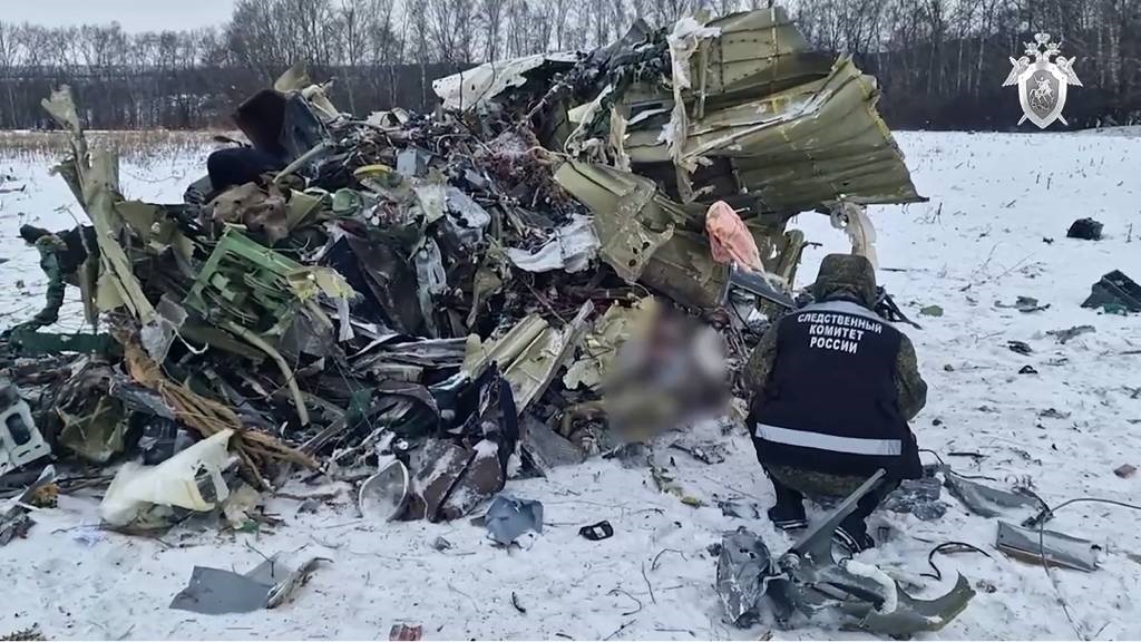 This grab taken from a handout footage released by the Russian Investigative Committee on 25 January 2024 shows what investigators say is the Russian IL-76 military transport plane crash site in the Belgorod region. 