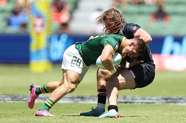 Ricardo Duarttee of South Africa  (left) gets tackled by Thomas Isherwood of Canada during the 2024 Perth SVNS on 26 January (Photo by Paul Kane/Getty Images)