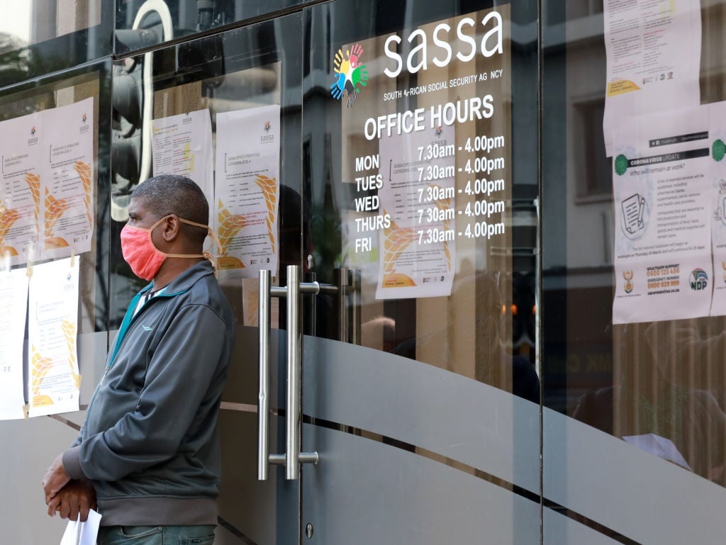 A man stands outside a Sassa office in Cape Town during the coronavirus lockdown.  (Nardus Engelbrecht/Gallo Images via Getty Images)