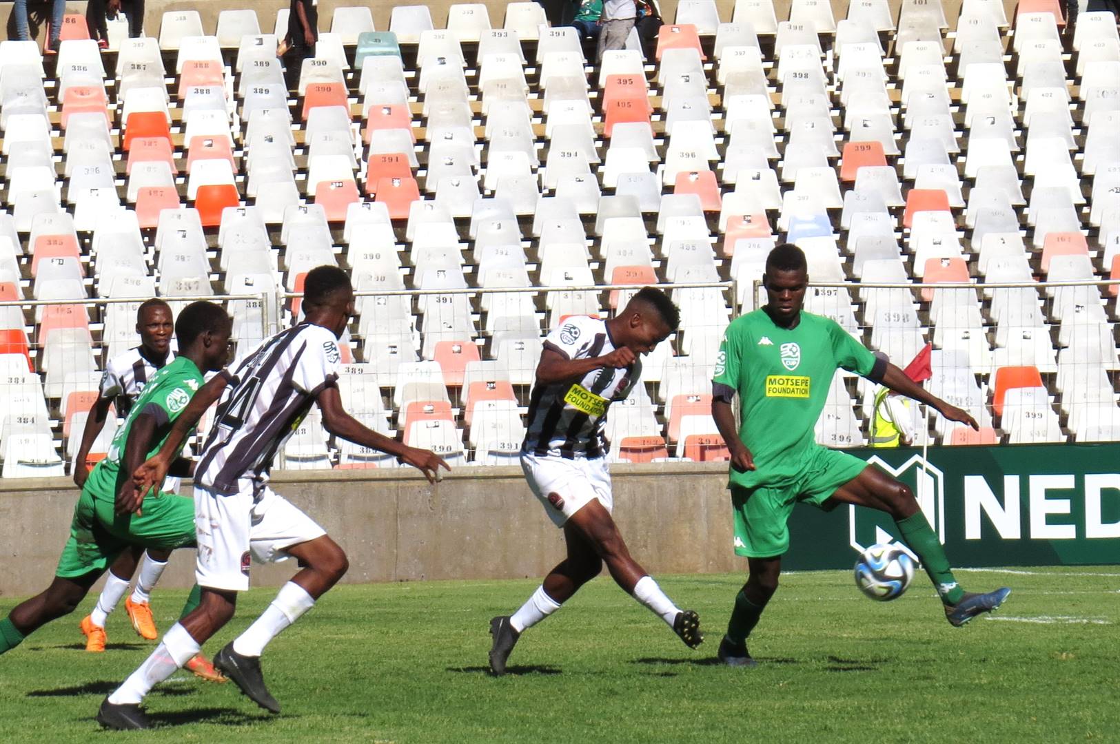 D’ General goal poacher Tladi Makhetha (in the black and white) scores a killer goal against the Limpopo-based Madridtas FC in the Nedbank Cup last-32 group fixure at the Toyota Stadium in Bloemfontein yesterday, on Sunday, 25 February. The striker beat opponent Rinaye Madzhuta (green) before scoring the second goal in the match.  Photo: Teboho Setena