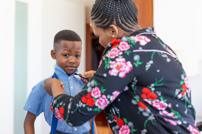 Mother getting her son ready for school (PHOTO: David F/Getty Images)