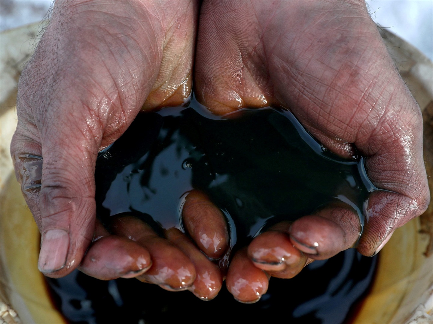An employee holds a sample of crude oil at the Yarakta oilfield, owned by Irkutsk Oil Company, in the Irkutsk region, Russia, on March 11, 2019. Vasily Fedosenko/Reuters