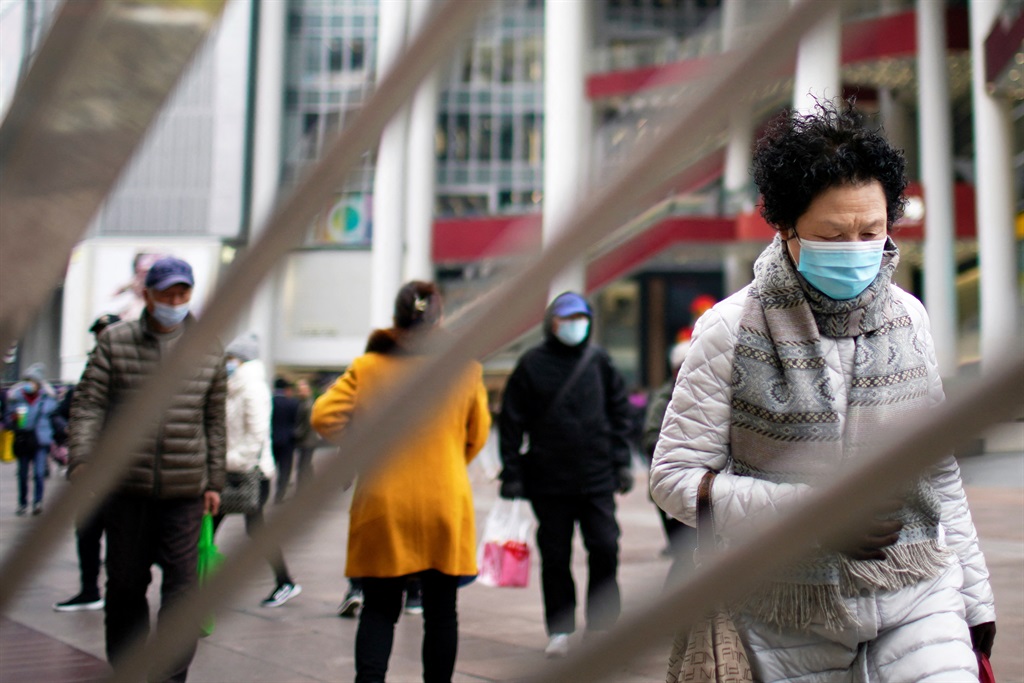 Mense loop Dinsdag in die strate van Shanghai. Foto: REUTERS/Aly Song