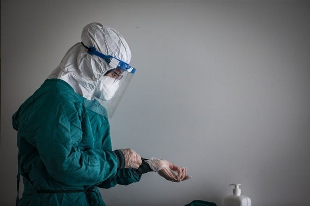 A healthcare worker wears protective suit, gloves, mask and glasses at Ankara City Hospital in Ankara, Turkey. 
