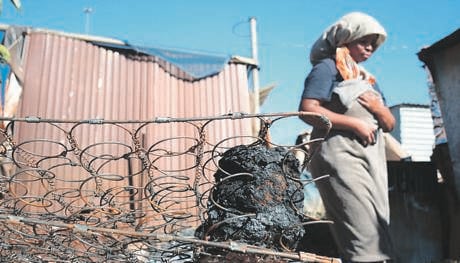 Portia Mohale from Mooiplaas in Tshwane says she doesn’t know what caused the blaze.                Photo by      Raymond Morare