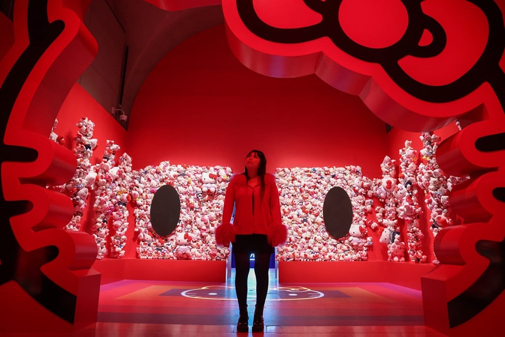 A gallery employee poses next to a Hello Kitty installation during a photocall of the exhibition CUTE at the Somerset House, central London, on 24 January 2024.