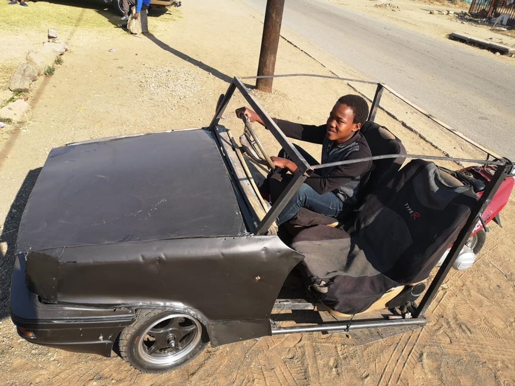 Obakeng Thetele shows-off his three-wheel car that he calls OTetle. Photo: Kabelo Tlhabanelo